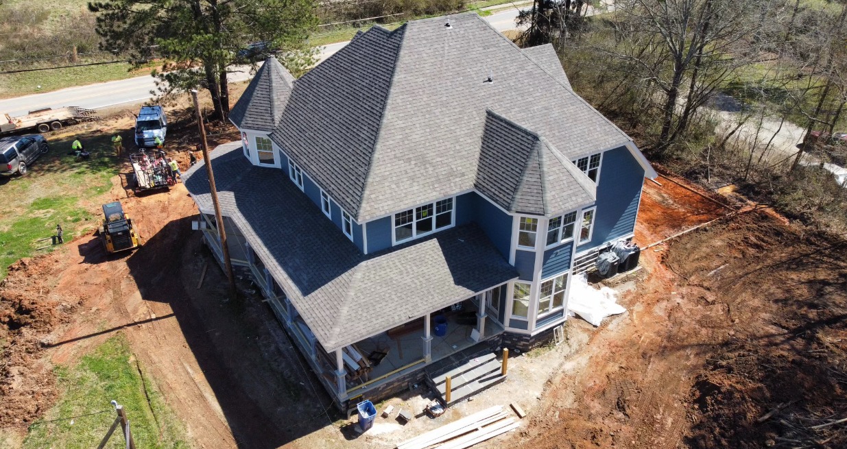 Aerial drone view of a Legacy Oaks custom home under construction