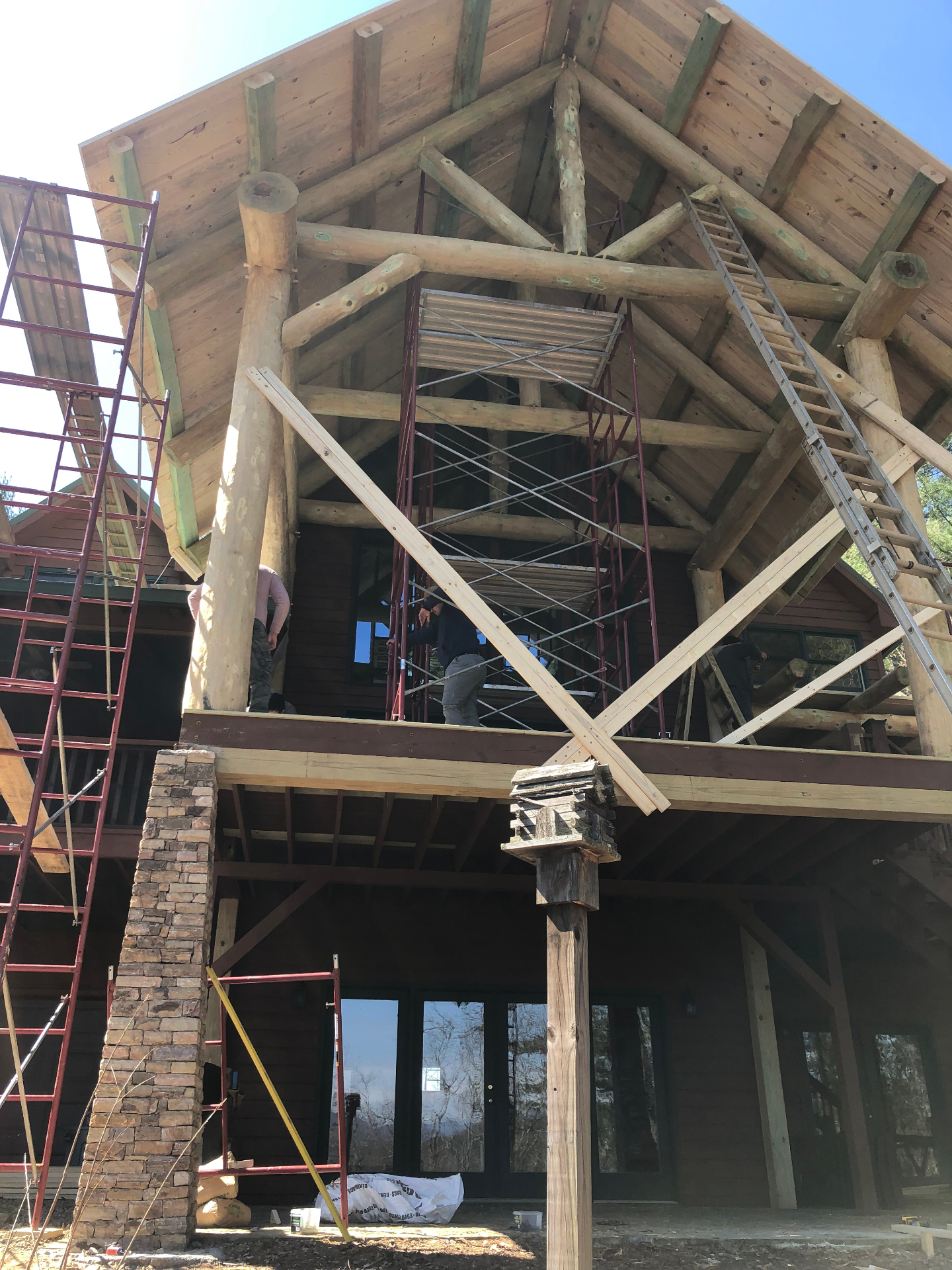 Timber-frame entry with heavy log columns under a cathedral ceiling