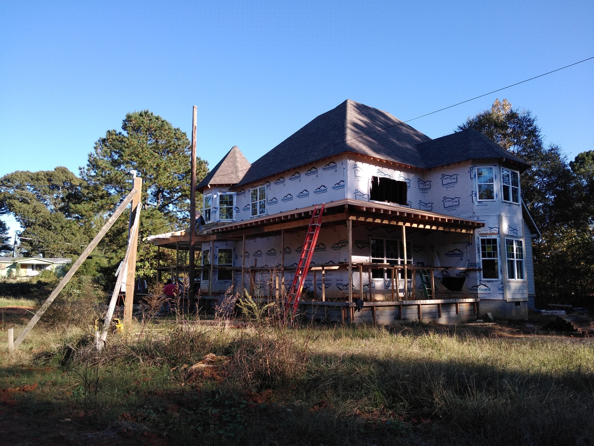 Finished covered porch with columns and beadboard ceiling