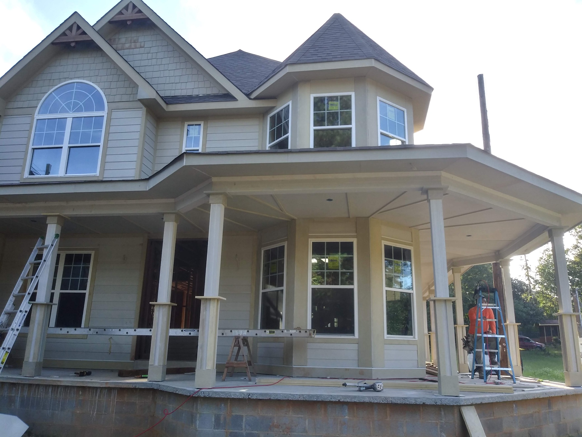 Finished shingle roof and shake gables on a custom home at dusk